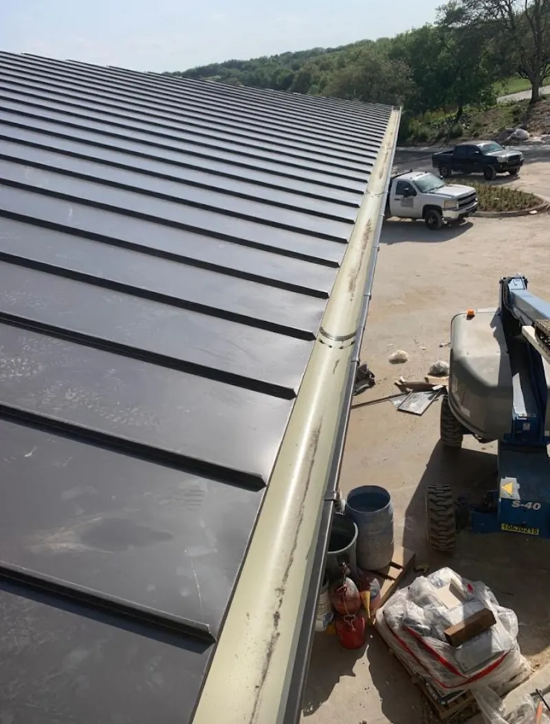 Standing seam panel and gutter detail on a metal roofing jobsite in Goldsboro
